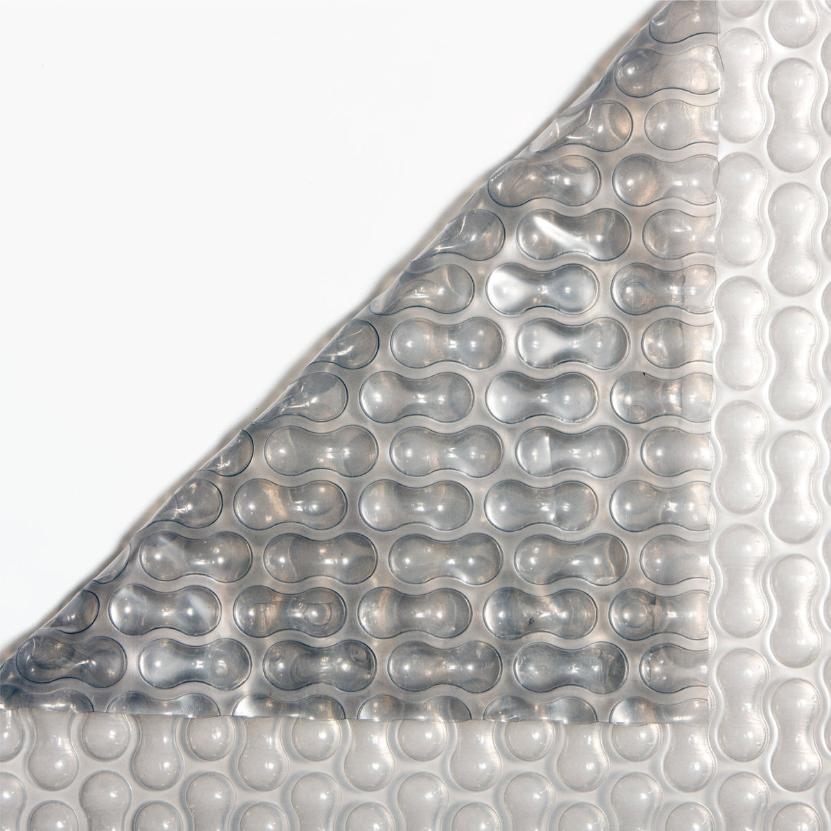 GeoBubble Gen2 Sol+Guard™ clear solar pool cover, corner folded to show both sides of the bubble material