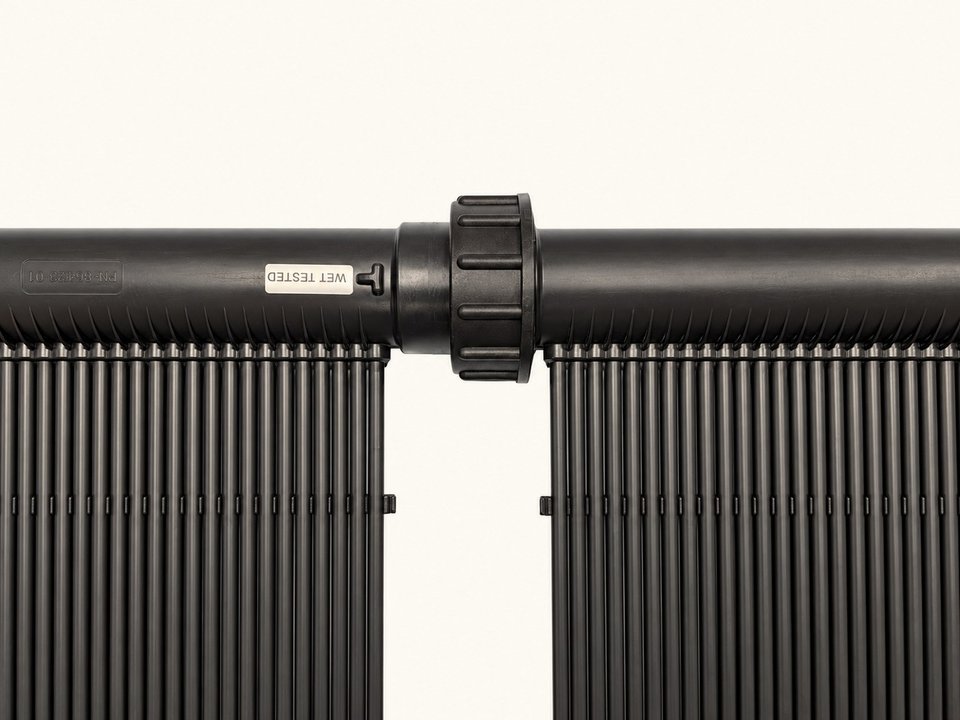 Two SunLink Pro panel headers joined by the union collar, twisted closed with no hose or clamp