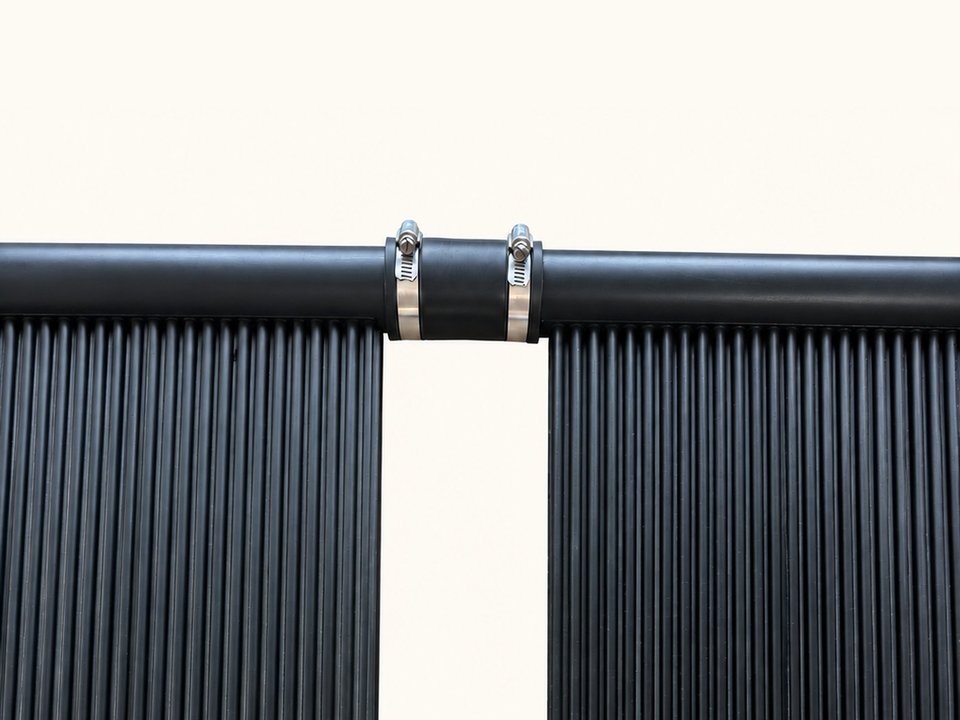 Two SwimEasy panel headers joined by a short rubber hose with a stainless hose clamp at each end