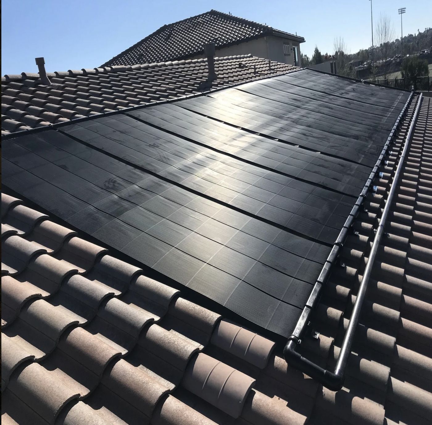 SwimJoy panels flush-mounted on a tile roof
