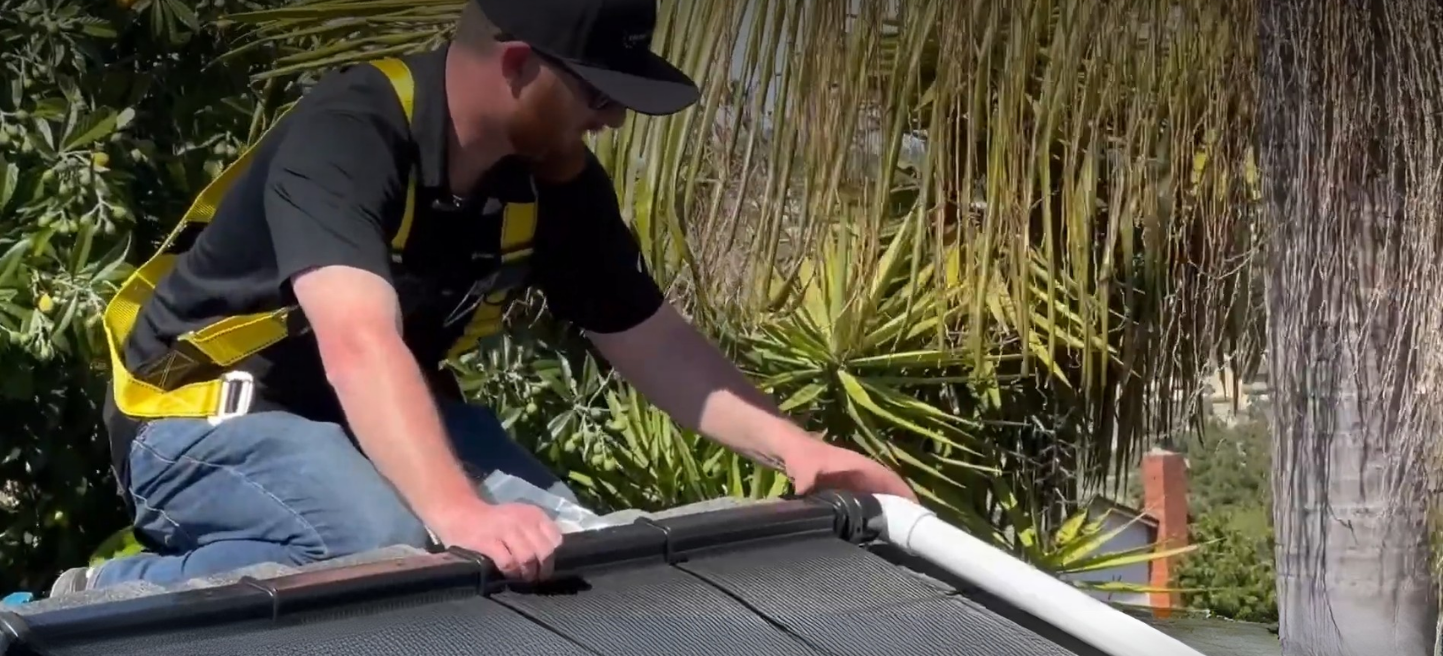 Installer on roof with solar panels