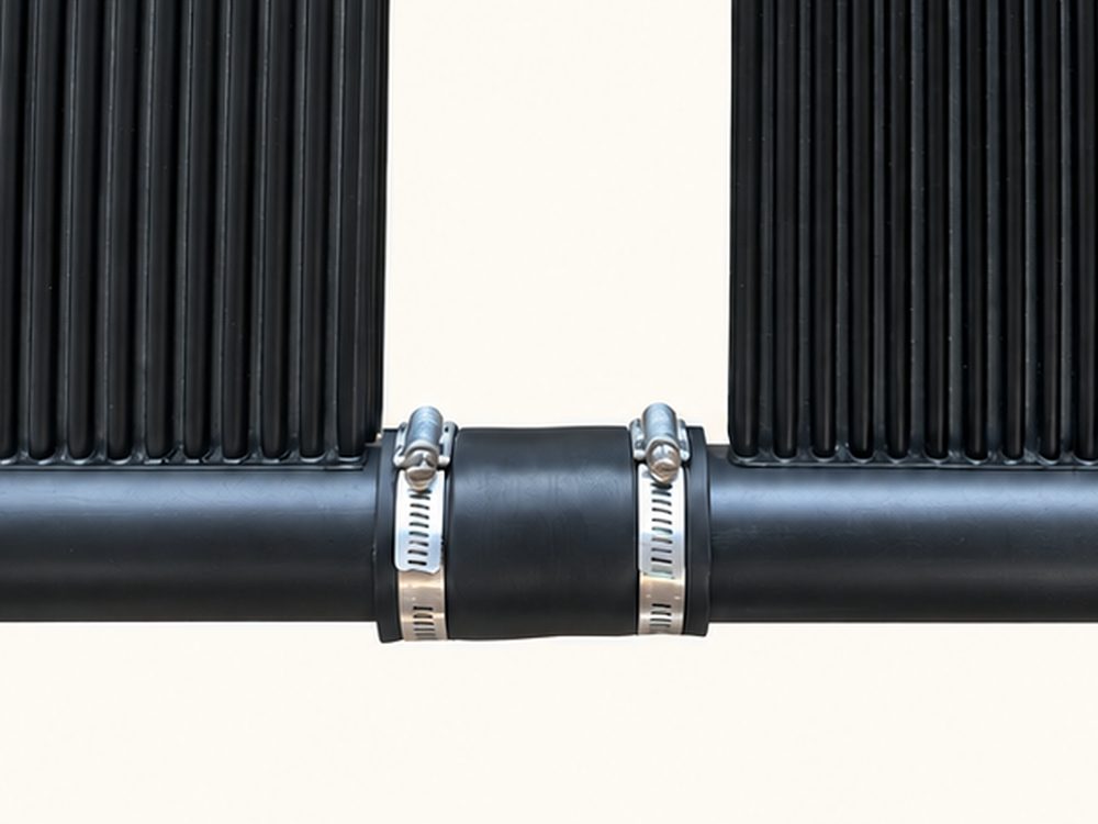 Two panel headers joined by a rubber hose and two stainless hose clamps