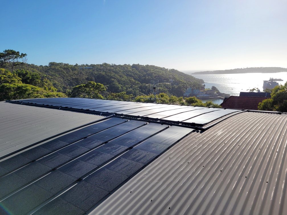 SunLink Pro solar collectors installed on a rooftop overlooking the coast